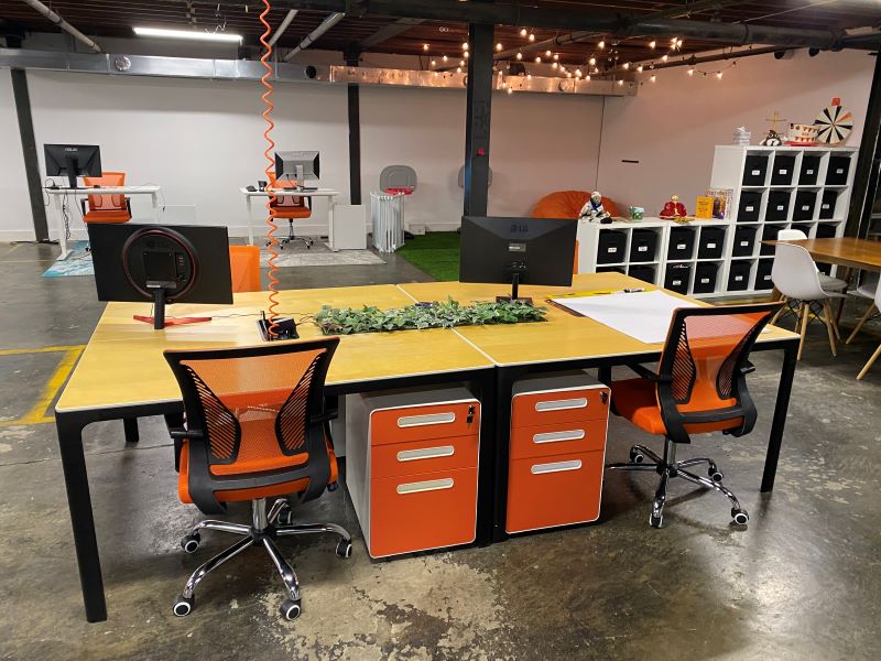 Four desks with chairs that are available for rental.